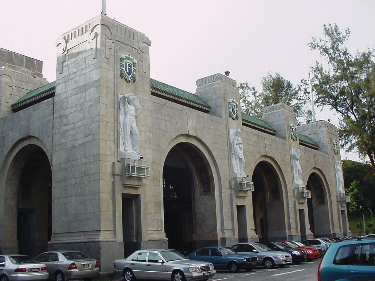 Four statues made from Carrara marble stand at the entrance portico of the KTM Tanjong Pagar Railway Station. Photo taken by the author.